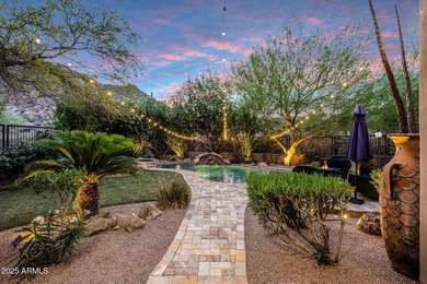Positioned on an elevated, double-gated homesite within the