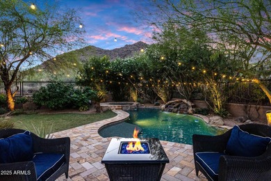 Positioned on an elevated, double-gated homesite within the