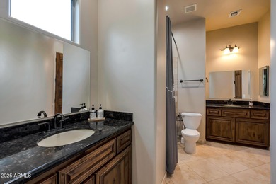 Positioned on an elevated, double-gated homesite within the