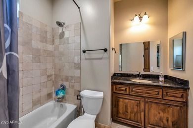 Positioned on an elevated, double-gated homesite within the