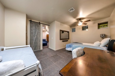 Positioned on an elevated, double-gated homesite within the