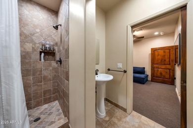 Positioned on an elevated, double-gated homesite within the