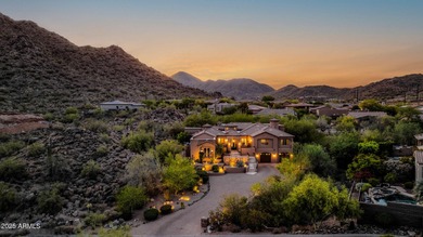 Positioned on an elevated, double-gated homesite within the