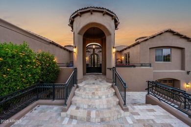 Positioned on an elevated, double-gated homesite within the