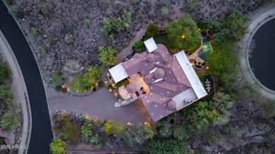 Positioned on an elevated, double-gated homesite within the