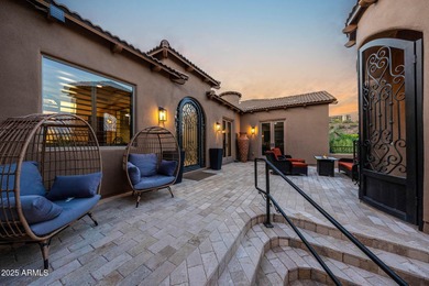 Positioned on an elevated, double-gated homesite within the