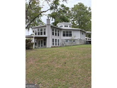 This metal roofed octagon home is in a protected cove off the - photo 1