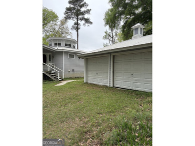 This metal roofed octagon home is in a protected cove off the - photo 2