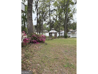 This metal roofed octagon home is in a protected cove off the - photo 4
