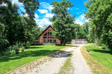 Tucked away on 6.6 wooded acres, this 3-bedroom, 2-bath home - photo 2