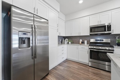 Welcome to 5933 Sunstone Dr #410, a modern luxury condo with 2