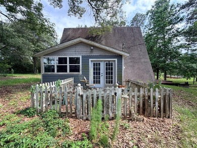 Tucked away on 7.6+ acres of unrestricted, lakefront land on - photo 12