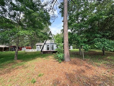 Tucked away on 7.6+ acres of unrestricted, lakefront land on - photo 28