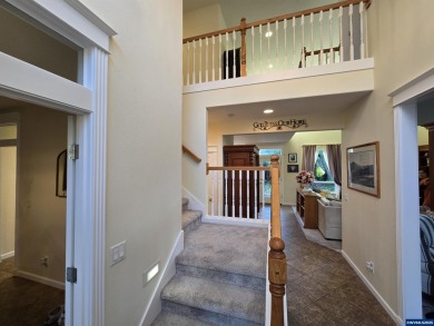 Exquisite home features vaulted ceilings & arched windows