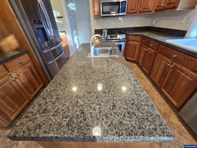 Exquisite home features vaulted ceilings & arched windows