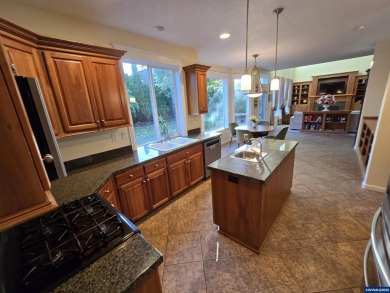 Exquisite home features vaulted ceilings & arched windows