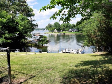 Nestled along the peaceful shoreline of a sheltered cove with - photo 2