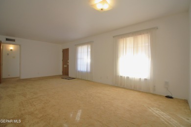 This charming single-level brick home in the highly desirable