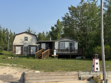 Lake Home For Sale in Carp Lake, Michigan