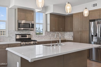 Open-concept living with high ceilings, wide-plank laminate