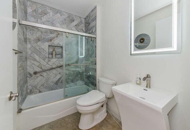 The main level offers a newer custom kitchen with marble - photo 7
