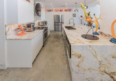 The main level offers a newer custom kitchen with marble - photo 9