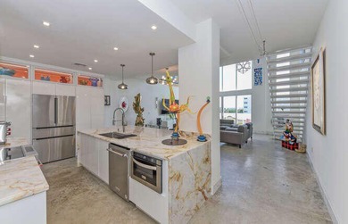 The main level offers a newer custom kitchen with marble - photo 10