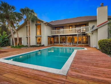Set behind a curtain of mature landscaping and shimmering water - photo 12