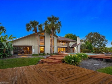 Set behind a curtain of mature landscaping and shimmering water - photo 15
