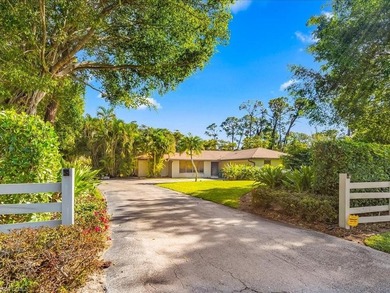 Set behind a curtain of mature landscaping and shimmering water - photo 16