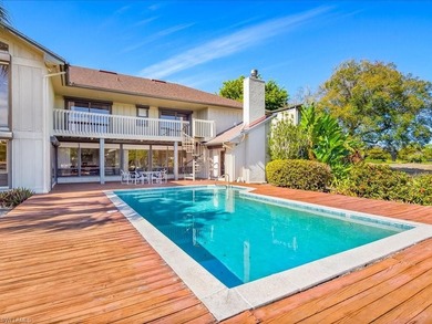 Set behind a curtain of mature landscaping and shimmering water - photo 21