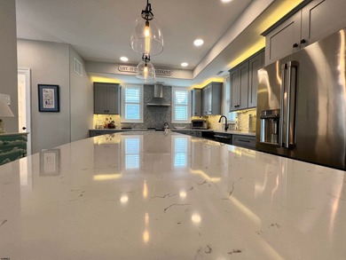 Welcome to this stunning Dean Adams-built beach block 5-bedroom