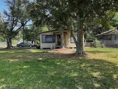 Nestled under beautiful tress located on a corner lot in the - photo 1