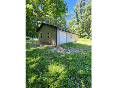 Versatile 20' x 40' steel-sided garage situated on a small - photo 3