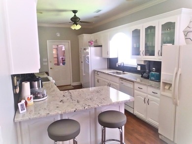 Tour this well-maintained 3BR/2BA custom brick home located in