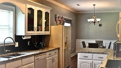 Tour this well-maintained 3BR/2BA custom brick home located in