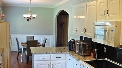 Tour this well-maintained 3BR/2BA custom brick home located in