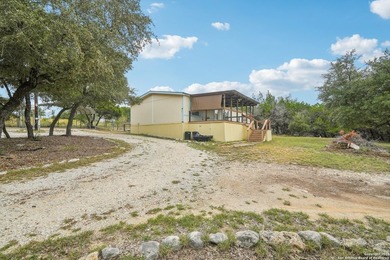 Set on over 1.3 acres in Lakehills, Texas, this 4-bedroom - photo 2