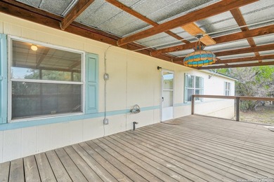 Set on over 1.3 acres in Lakehills, Texas, this 4-bedroom - photo 3
