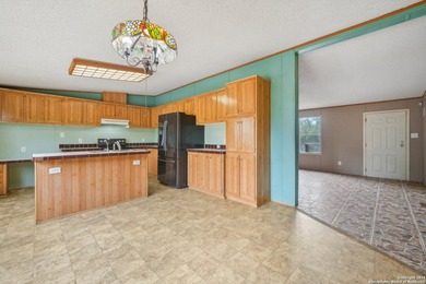 Set on over 1.3 acres in Lakehills, Texas, this 4-bedroom - photo 7