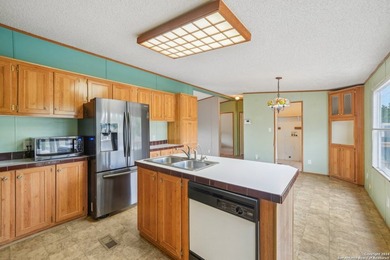 Set on over 1.3 acres in Lakehills, Texas, this 4-bedroom - photo 8