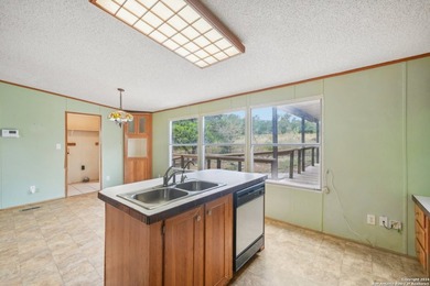 Set on over 1.3 acres in Lakehills, Texas, this 4-bedroom - photo 9