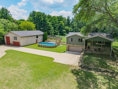 Nestled on over two acres in peaceful Grass Lake, this - photo 1