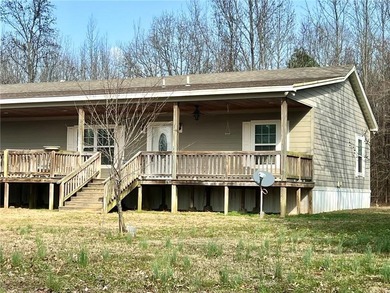 Well-maintained home on approximately 6 acres with a stocked