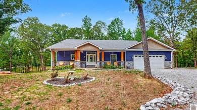 Tucked into a wooded setting just minutes from Kentucky Lake and - photo 1