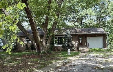 Nestled on a cul-de-sac, this inviting brick home sits on a - photo 1
