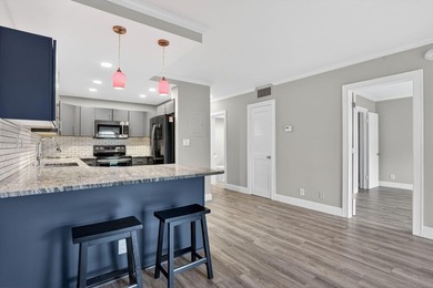 This condominium features an open kitchen, equipped with new - photo 3