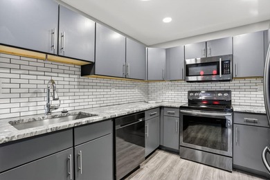 This condominium features an open kitchen, equipped with new - photo 5