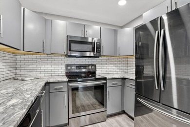 This condominium features an open kitchen, equipped with new - photo 6