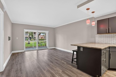 This condominium features an open kitchen, equipped with new - photo 7